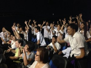 Deaf and blind students eagerly pose for cameras while waiting for the movie to start.